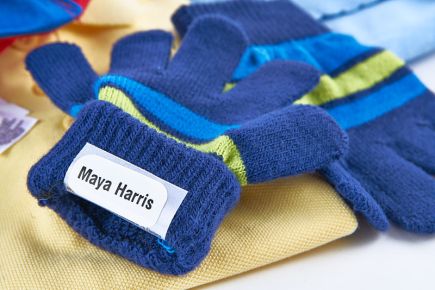 Stick name labels onto the wash-care label of fabric items
